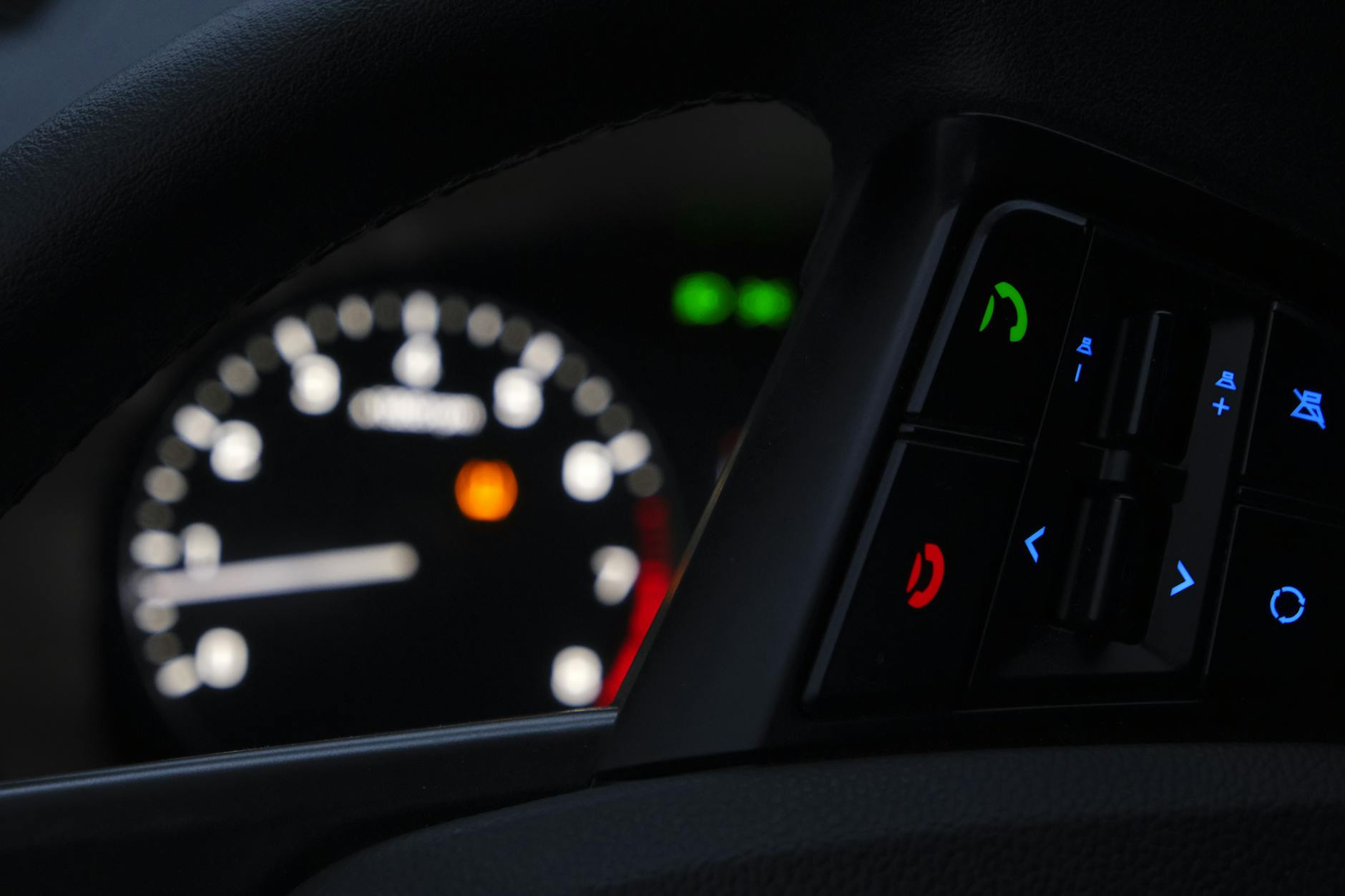 Vehicle dashboard displaying warning lights and temperature indicators