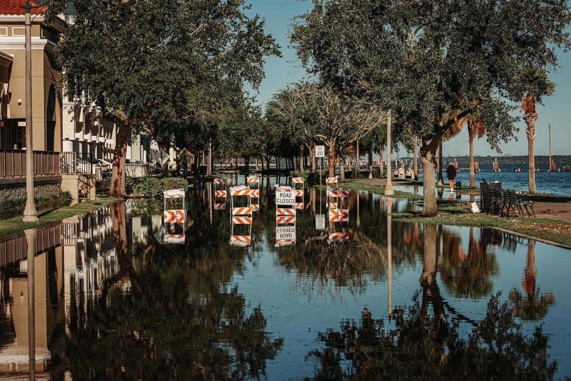 Flooded residential street with water covering roadway and yards