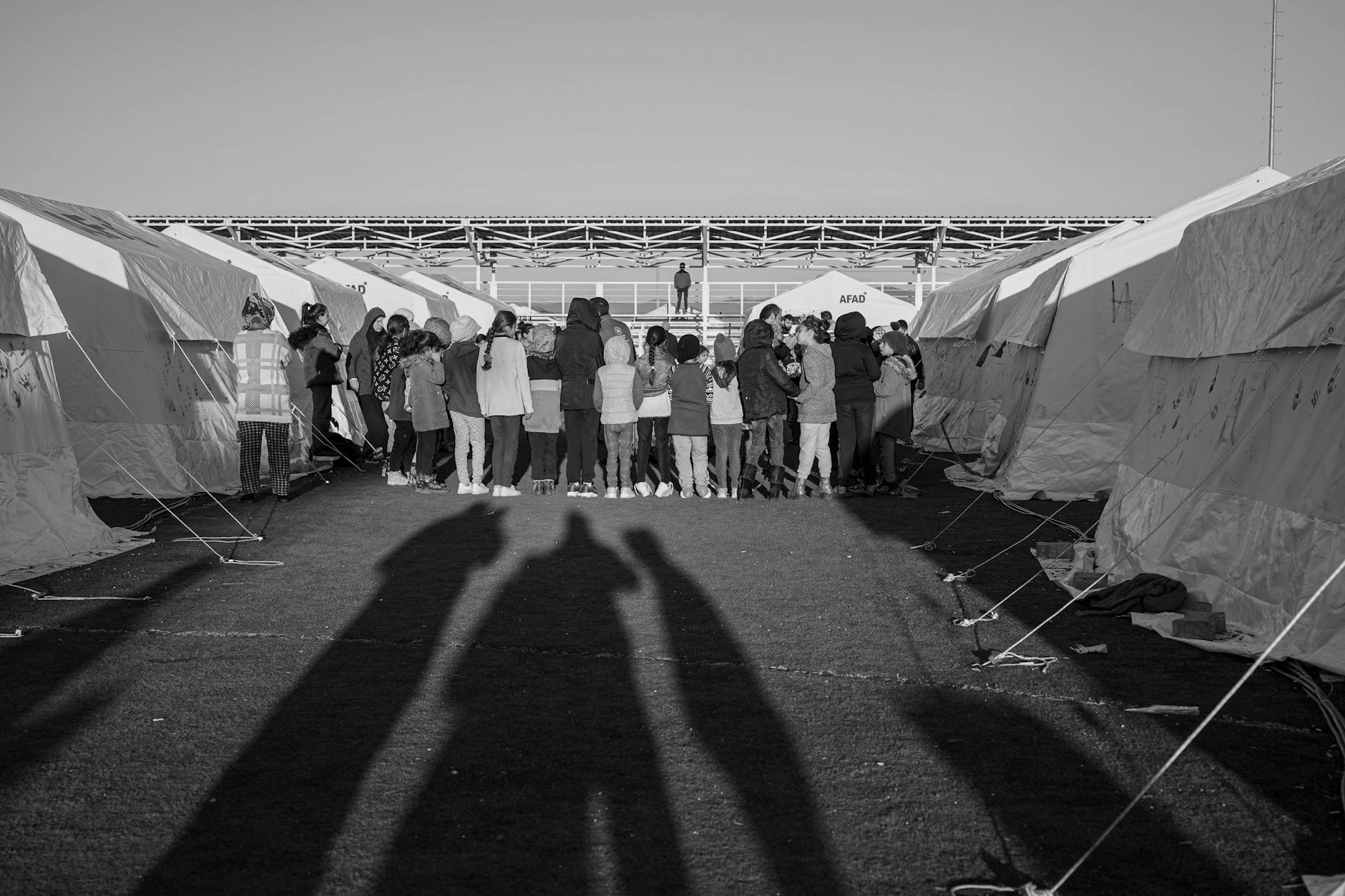 Emergency evacuation shelter with displaced families and relief supplies