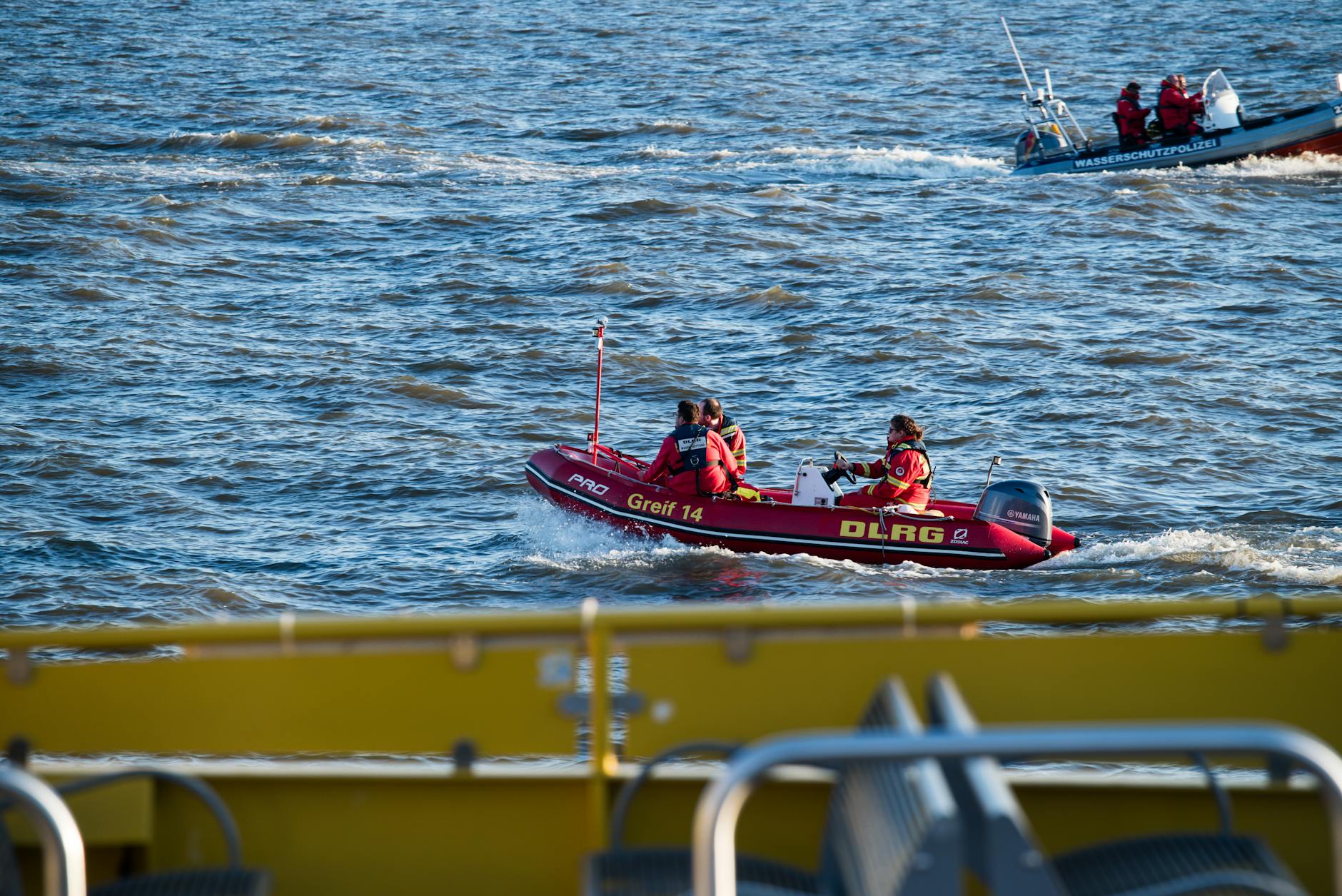 Emergency rescue boat navigating through flooded streets during evacuation operations