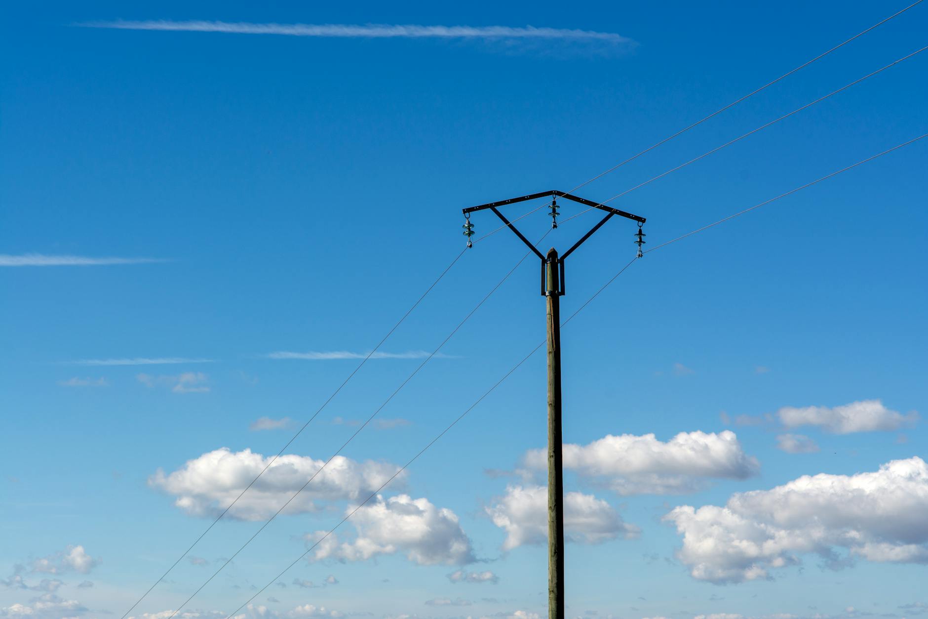 High voltage electrical transmission lines carrying power across landscape