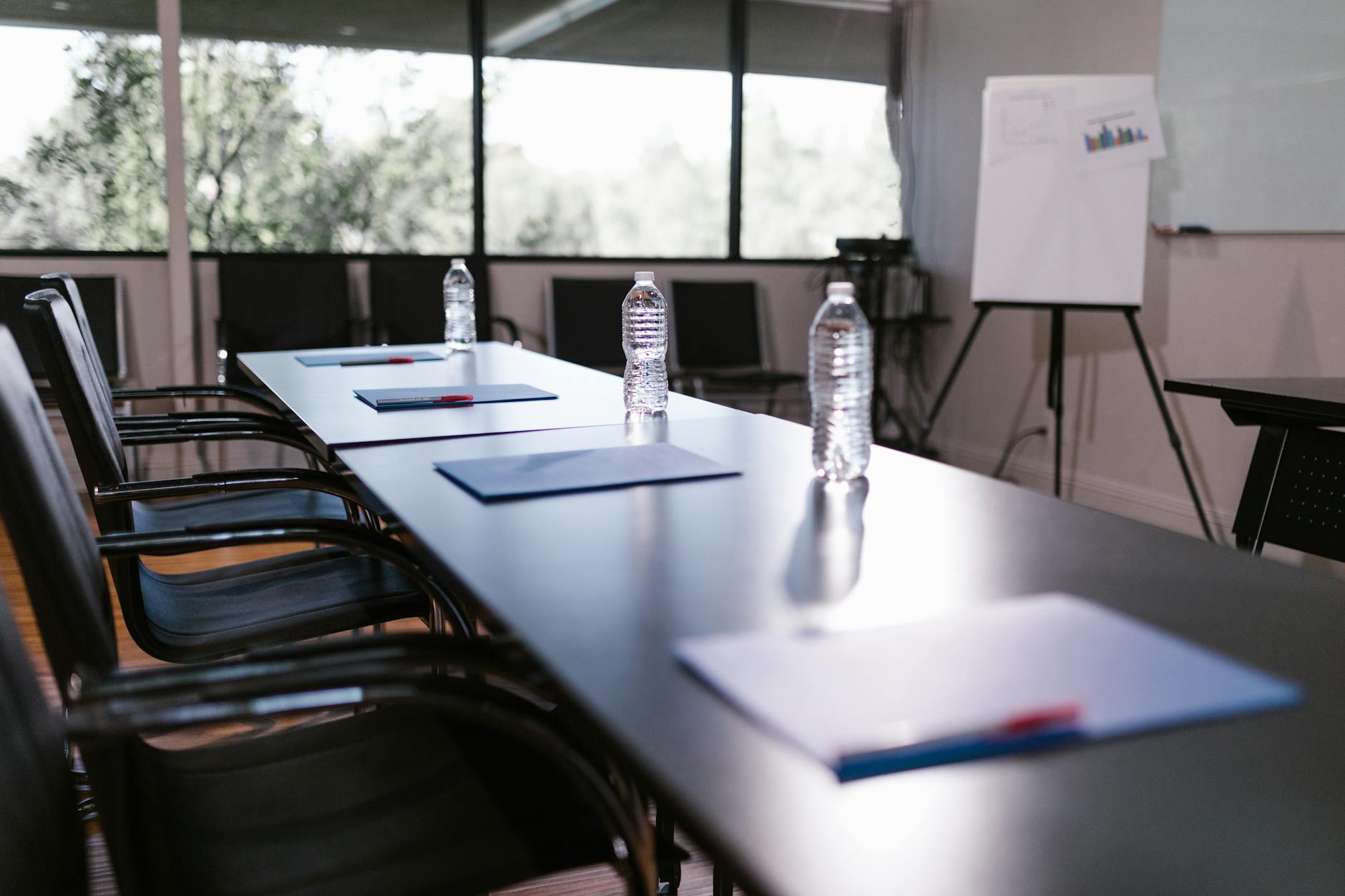 Empty corporate conference room with chairs around table