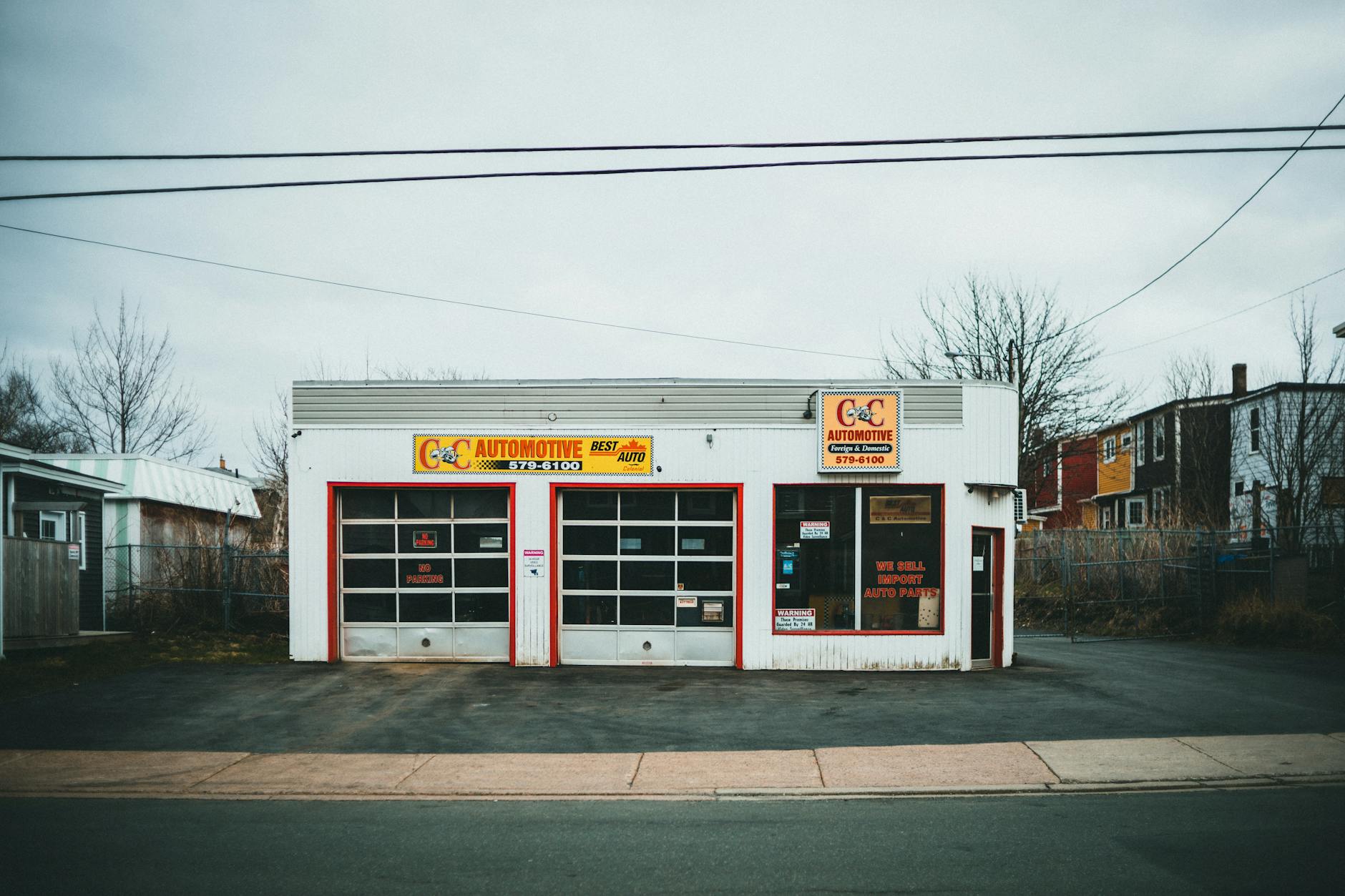 Modern automotive service center with technicians working on vehicles