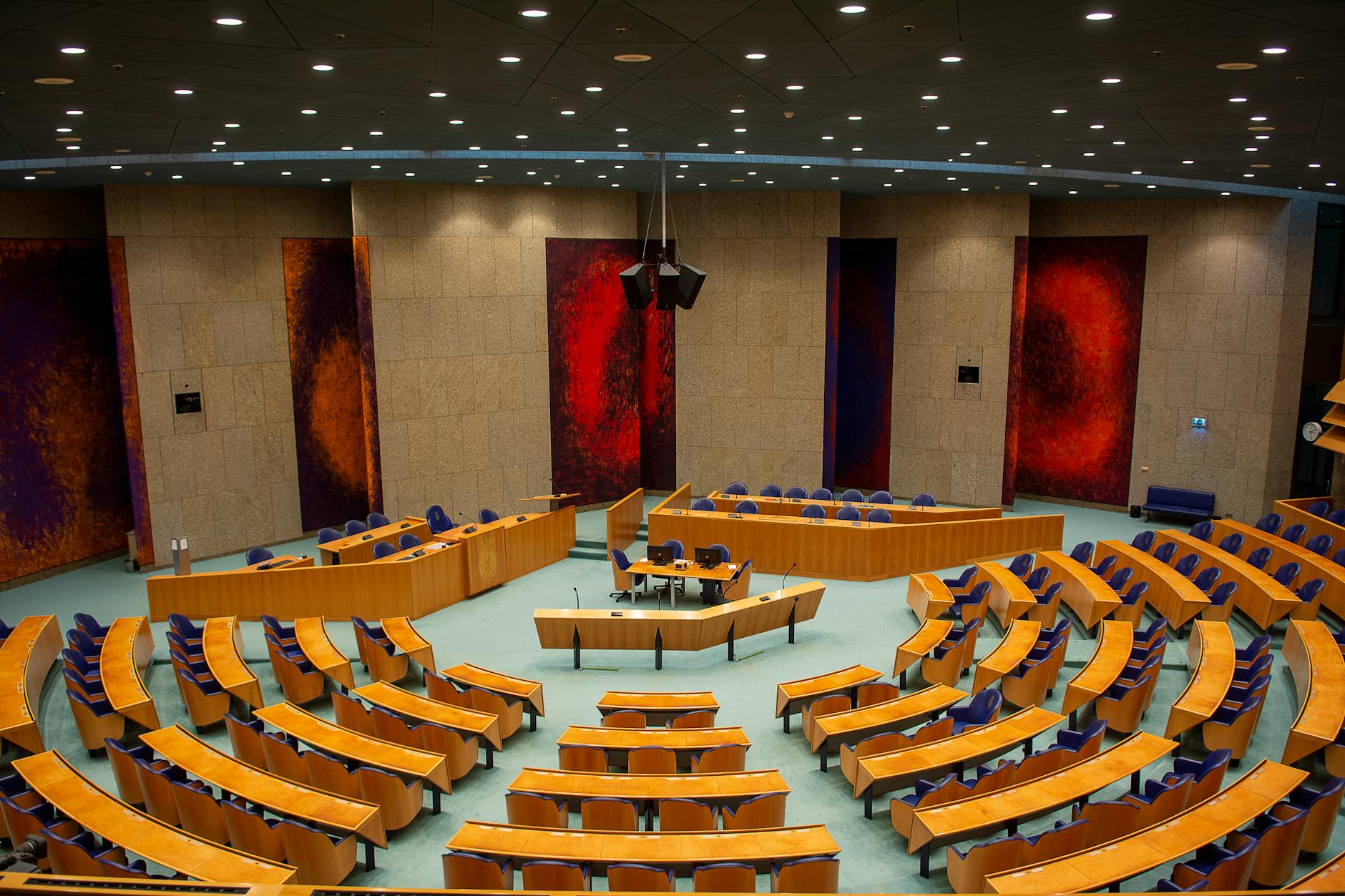 Politicians seated around conference table in formal government meeting room