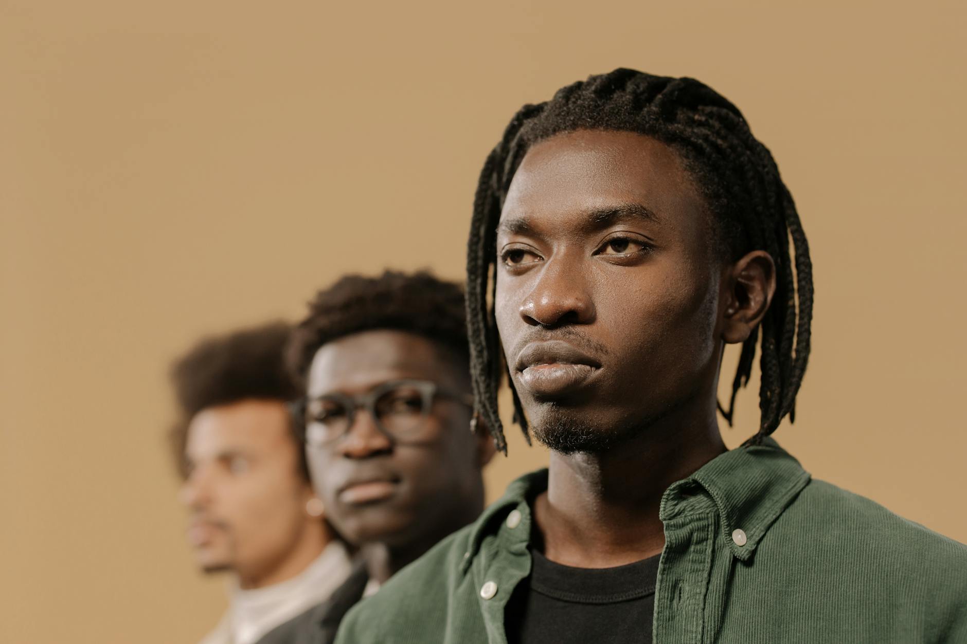 Group of young men in casual clothing standing together
