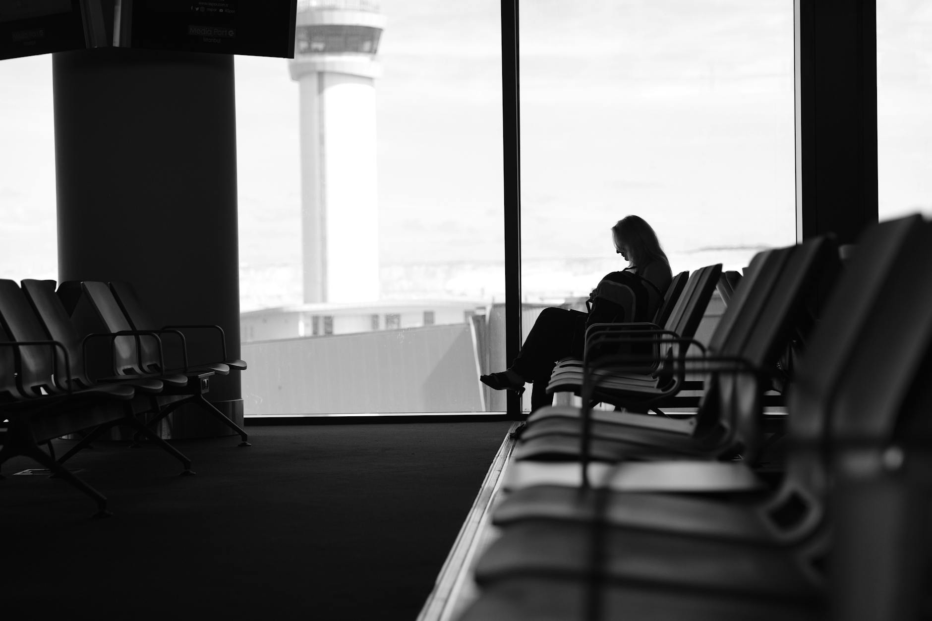 Group of travelers with luggage waiting in terminal area
