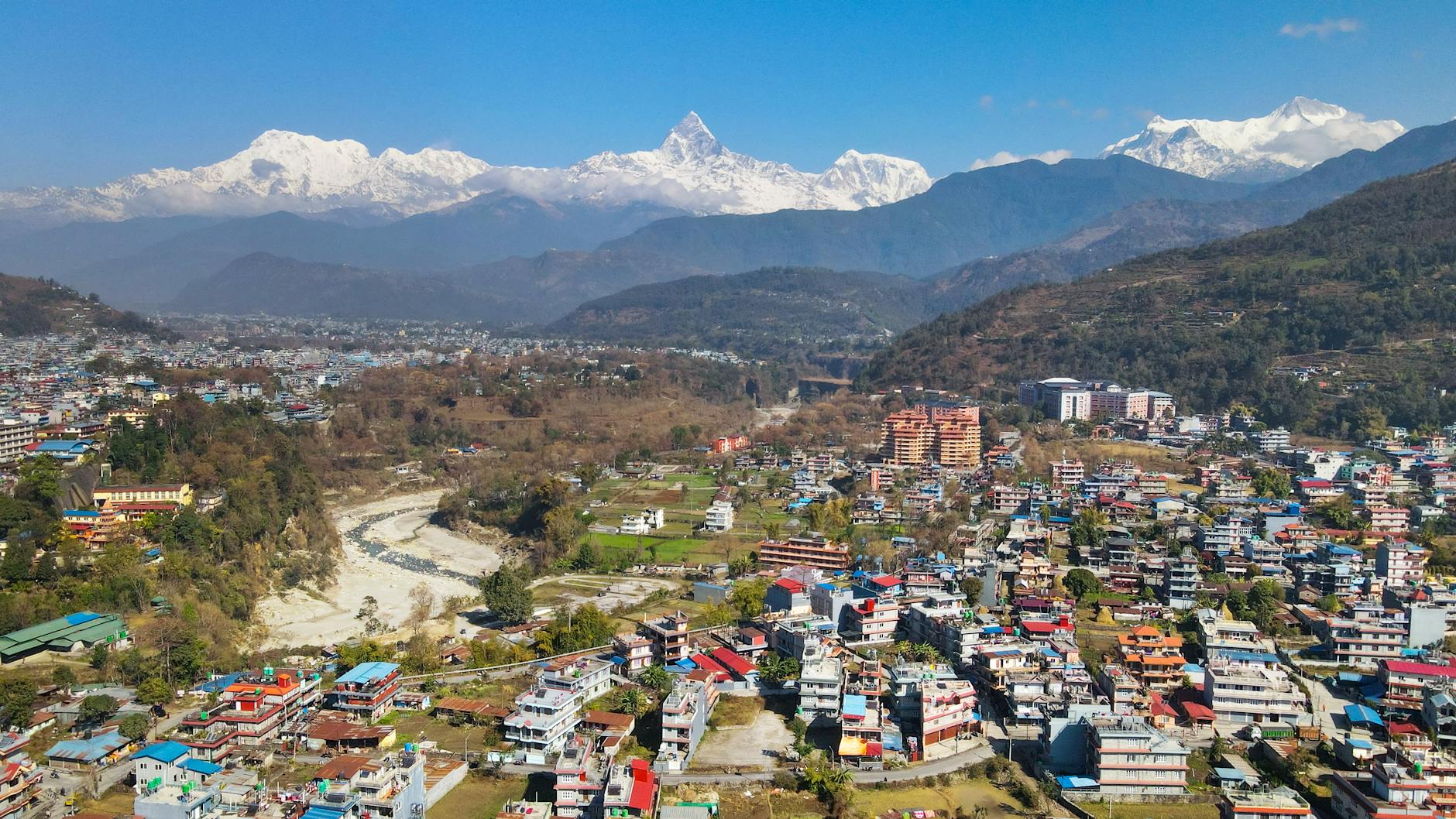Urban cityscape with mountains in background showing East Asian architecture
