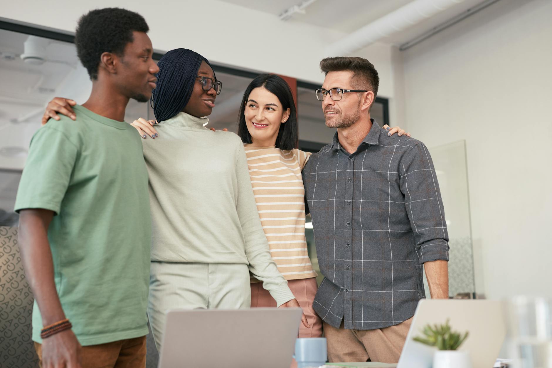 Diverse group of business professionals collaborating around a conference table with technology