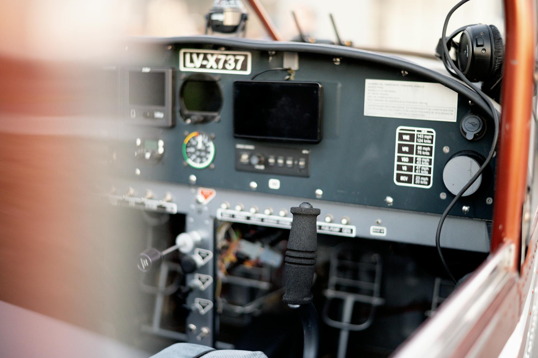 Commercial airline pilot in cockpit preparing for flight amid operational challenges