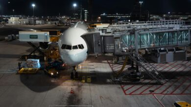 Cargo aircraft on airport tarmac with loading equipment nearby