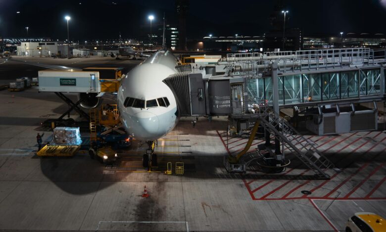 Cargo aircraft on airport tarmac with loading equipment nearby