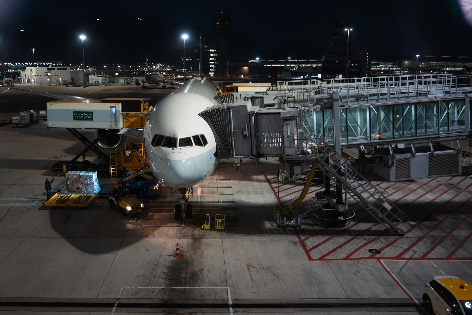Cargo aircraft on airport tarmac with loading equipment nearby