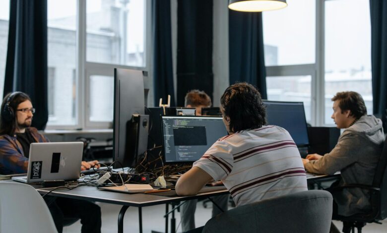 Business professionals discussing strategy in a modern tech office setting