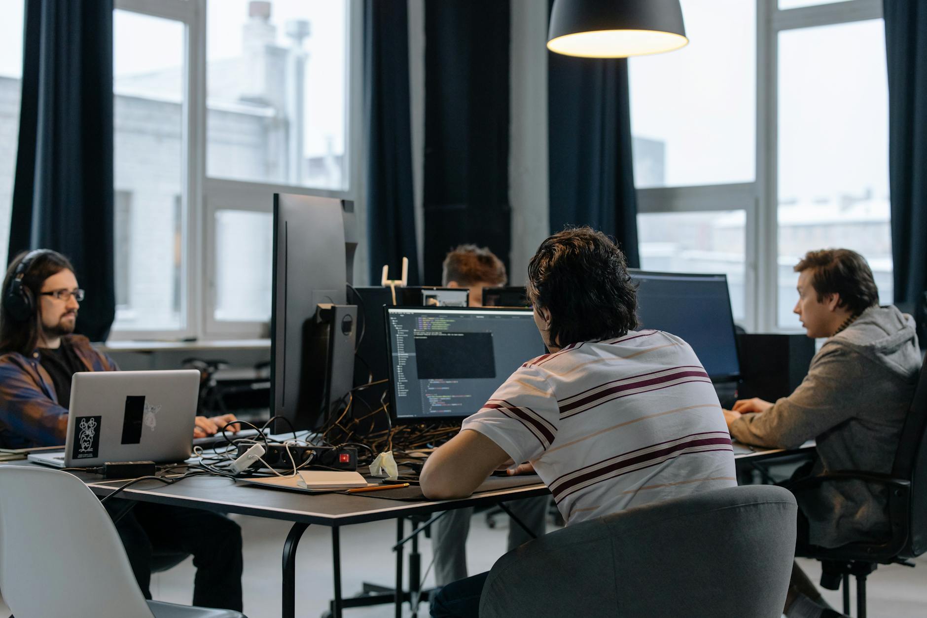 Business professionals discussing strategy in a modern tech office setting