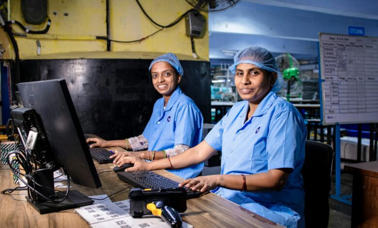 Workers on a smartphone assembly line in a modern manufacturing facility
