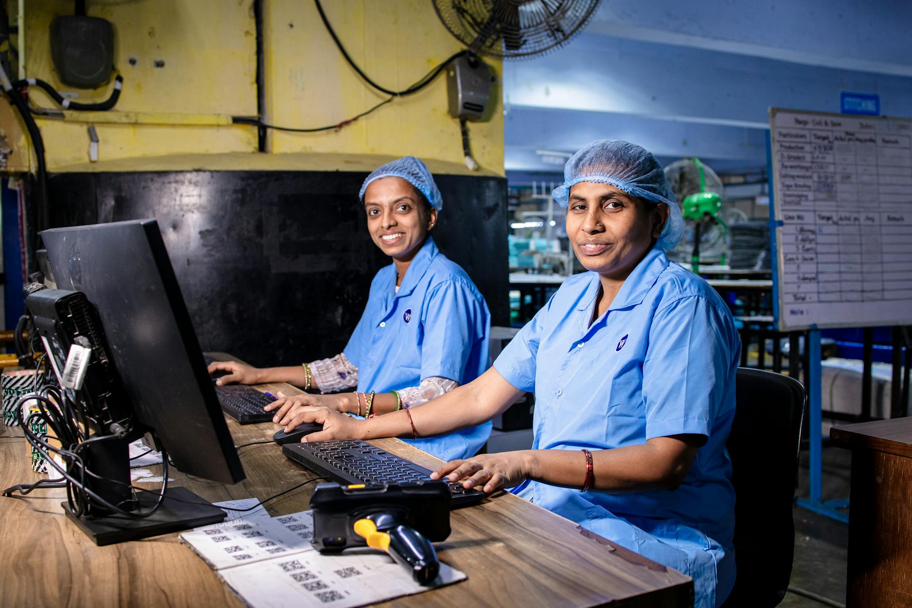 Workers on a smartphone assembly line in a modern manufacturing facility