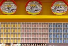 Wide view of a warehouse grocery store aisle stocked with bulk private label products