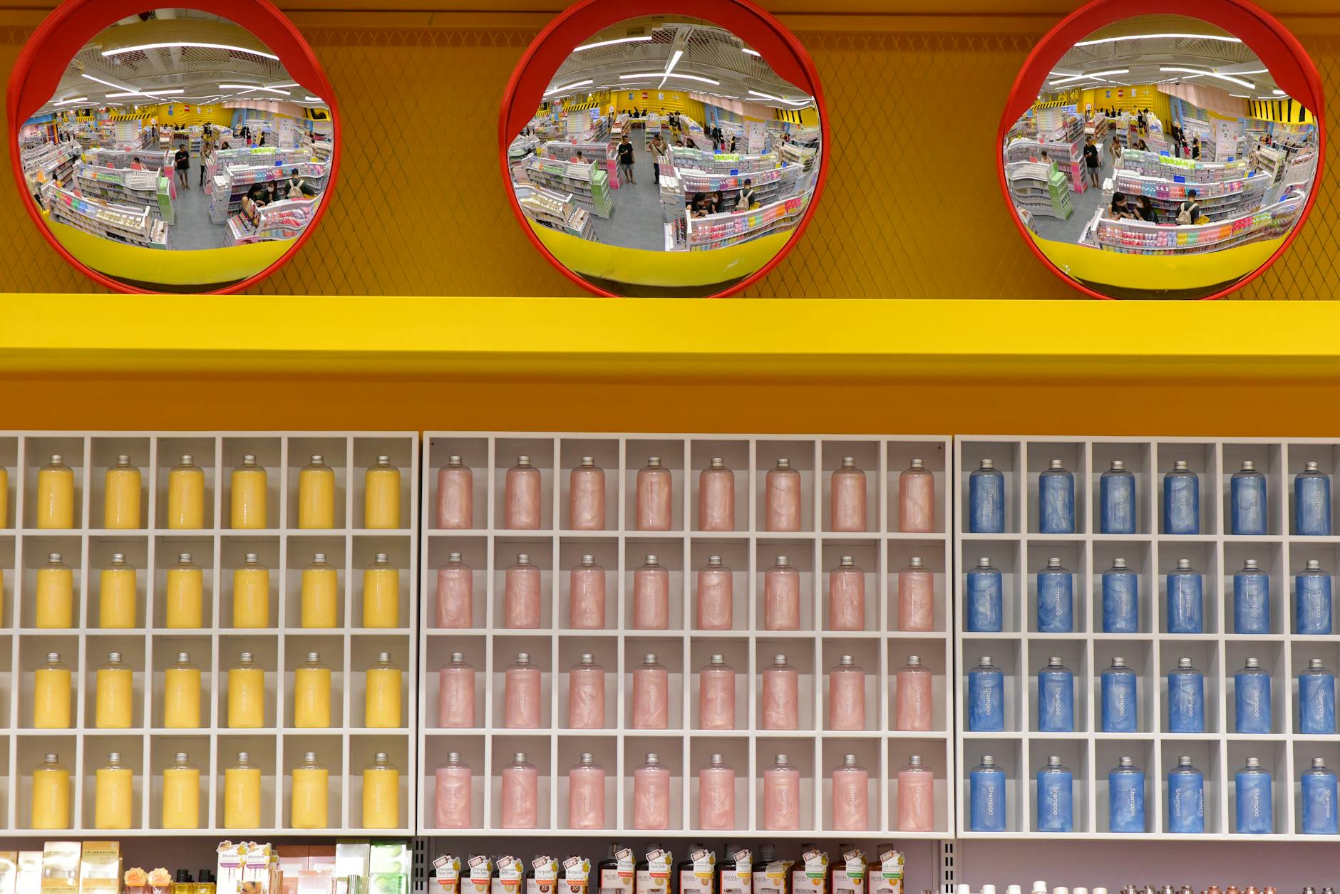 Wide view of a warehouse grocery store aisle stocked with bulk private label products