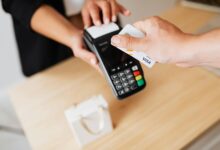 Customer paying with credit card at retail checkout terminal