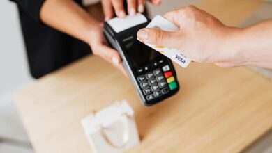 Customer paying with credit card at retail checkout terminal