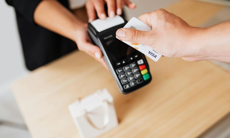Customer paying with credit card at retail checkout terminal