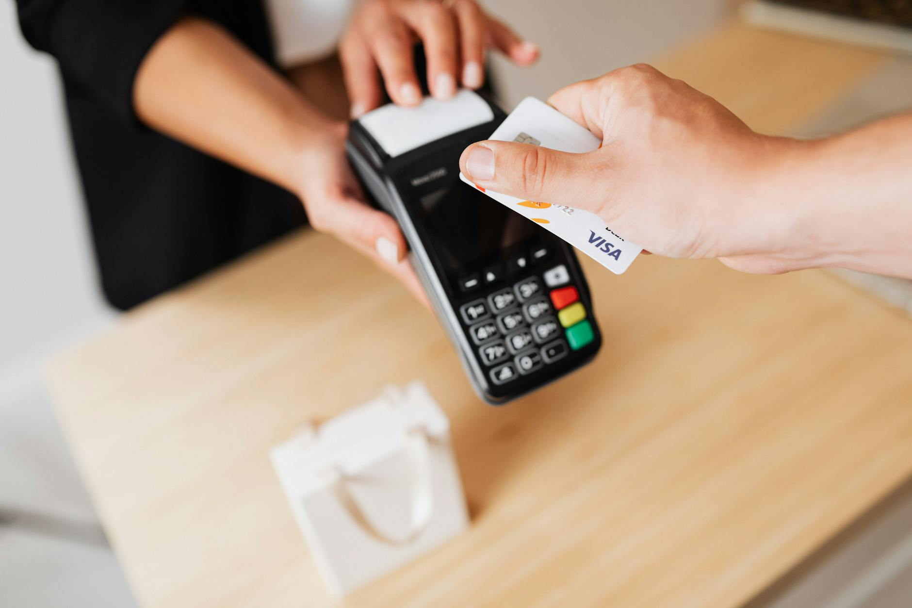 Customer paying with credit card at retail checkout terminal