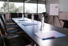 Empty corporate boardroom with chairs around a long table, representing executive decision-making