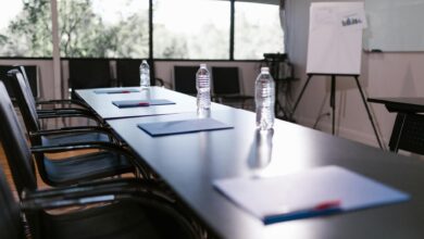 Empty corporate boardroom with chairs around a long table, representing executive decision-making