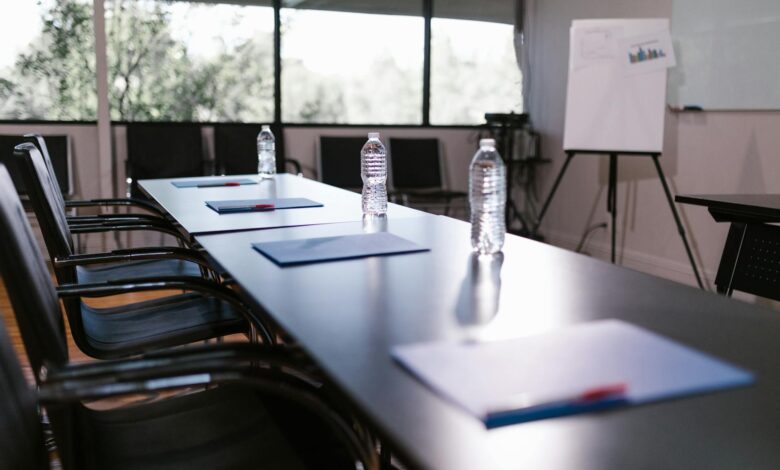 Empty corporate boardroom with chairs around a long table, representing executive decision-making