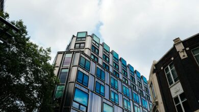 Glass office building exterior reflecting sky, representing commercial real estate vacancy concerns