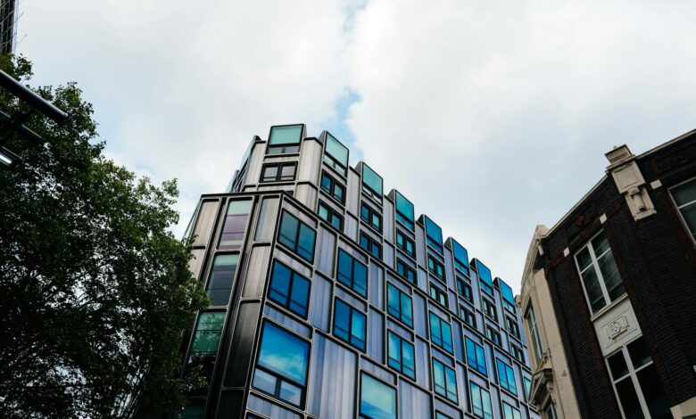Glass office building exterior reflecting sky, representing commercial real estate vacancy concerns