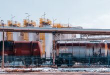 Large oil pipeline stretching across open terrain representing global crude supply infrastructure