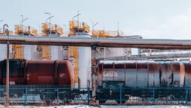 Large oil pipeline stretching across open terrain representing global crude supply infrastructure