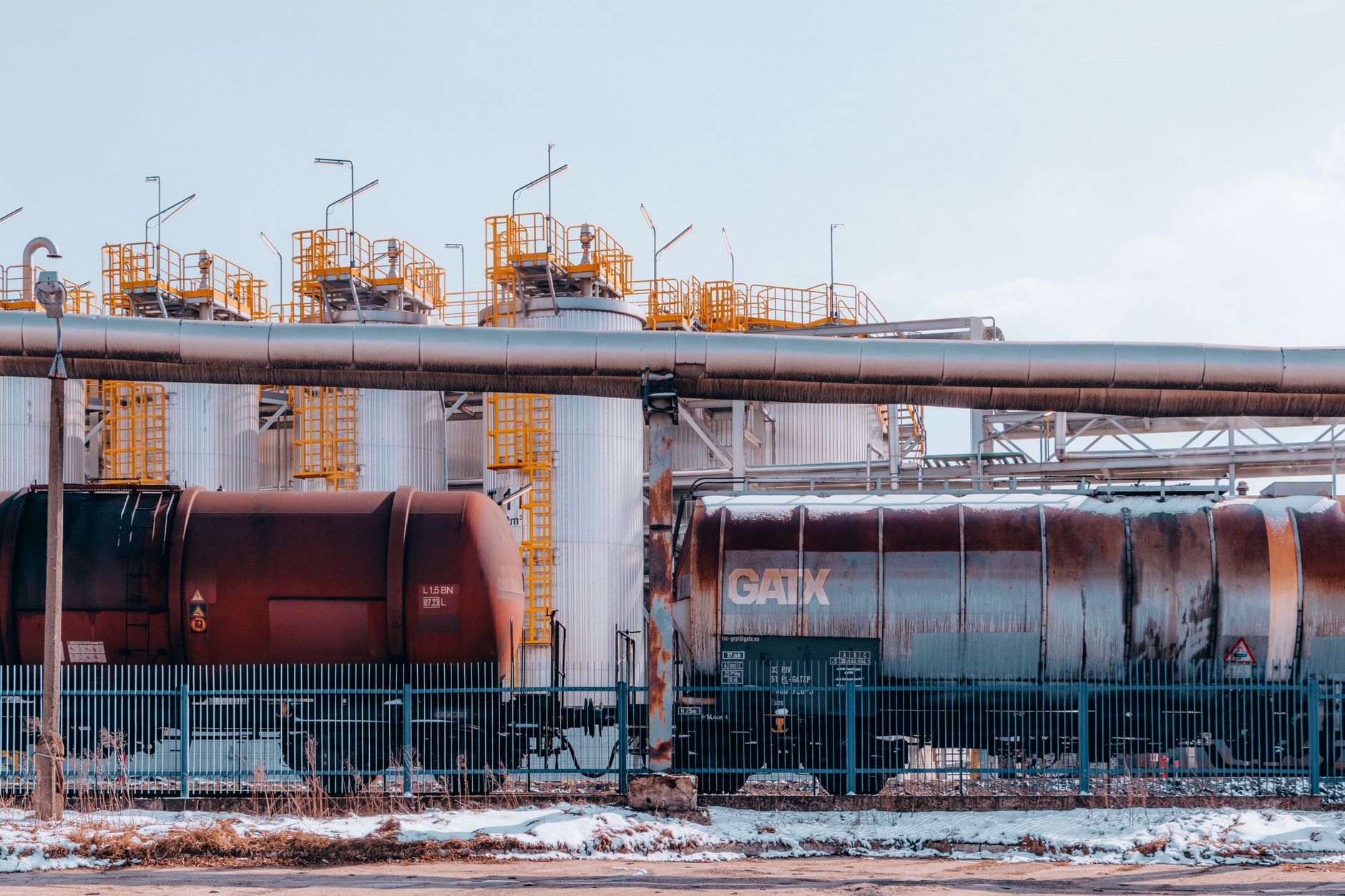 Large oil pipeline stretching across open terrain representing global crude supply infrastructure