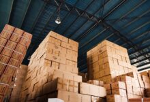 Large warehouse with shelves and logistics operations representing Amazon's marketplace infrastructure