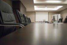 Modern corporate boardroom with conference table and chairs for executive meetings