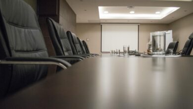 Modern corporate boardroom with conference table and chairs for executive meetings