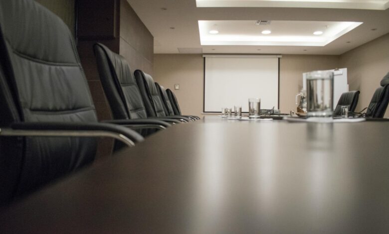 Modern corporate boardroom with conference table and chairs for executive meetings