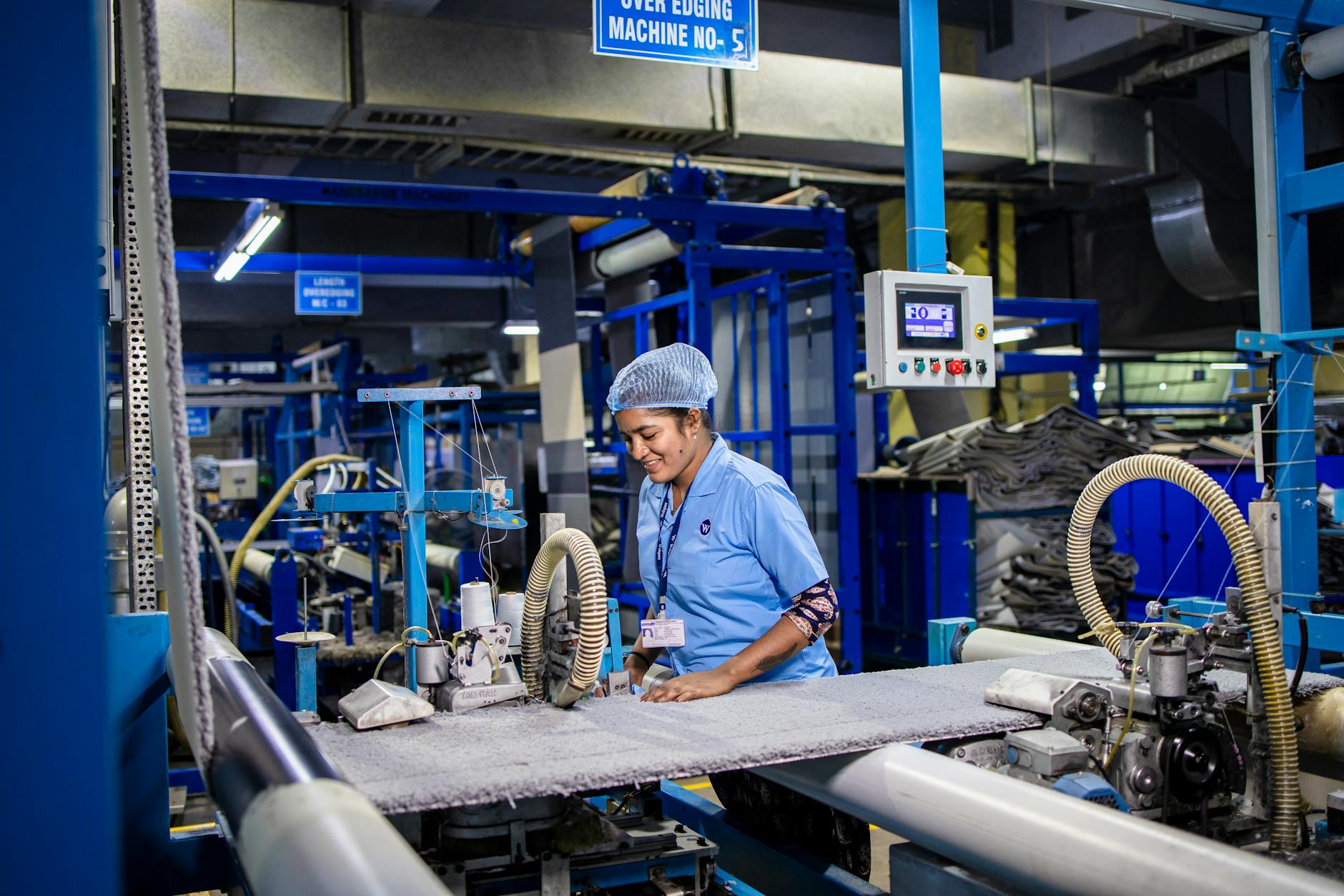 Industrial manufacturing facility in India with workers at production stations