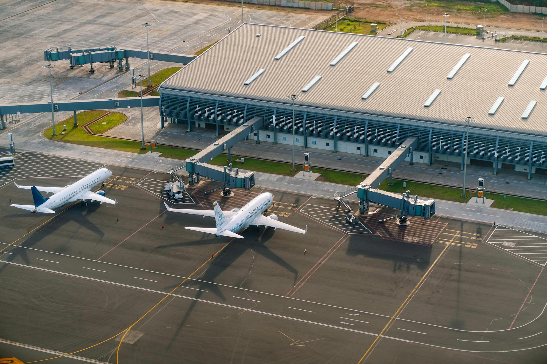 Passengers walking through a busy commercial airport terminal