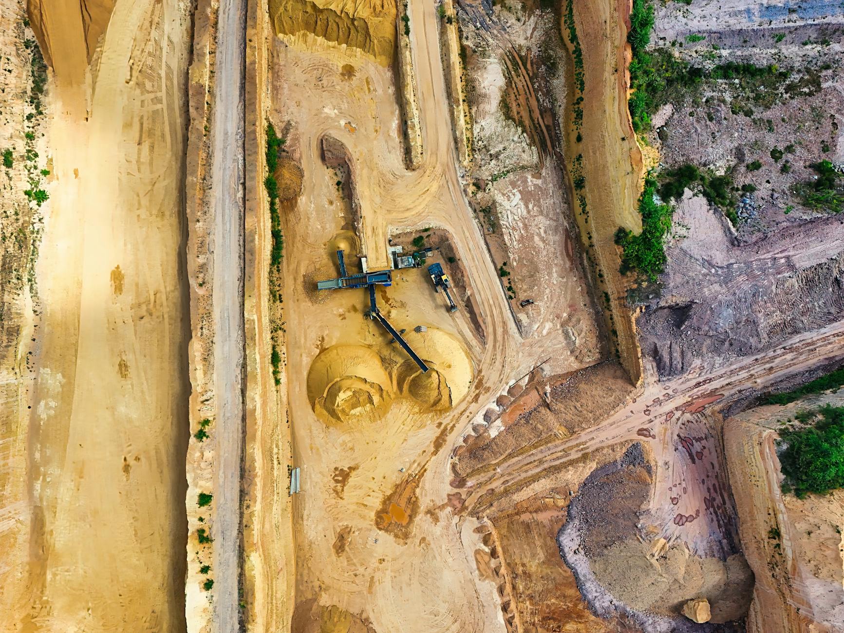 Aerial view of large-scale open mining operations in a remote desert region