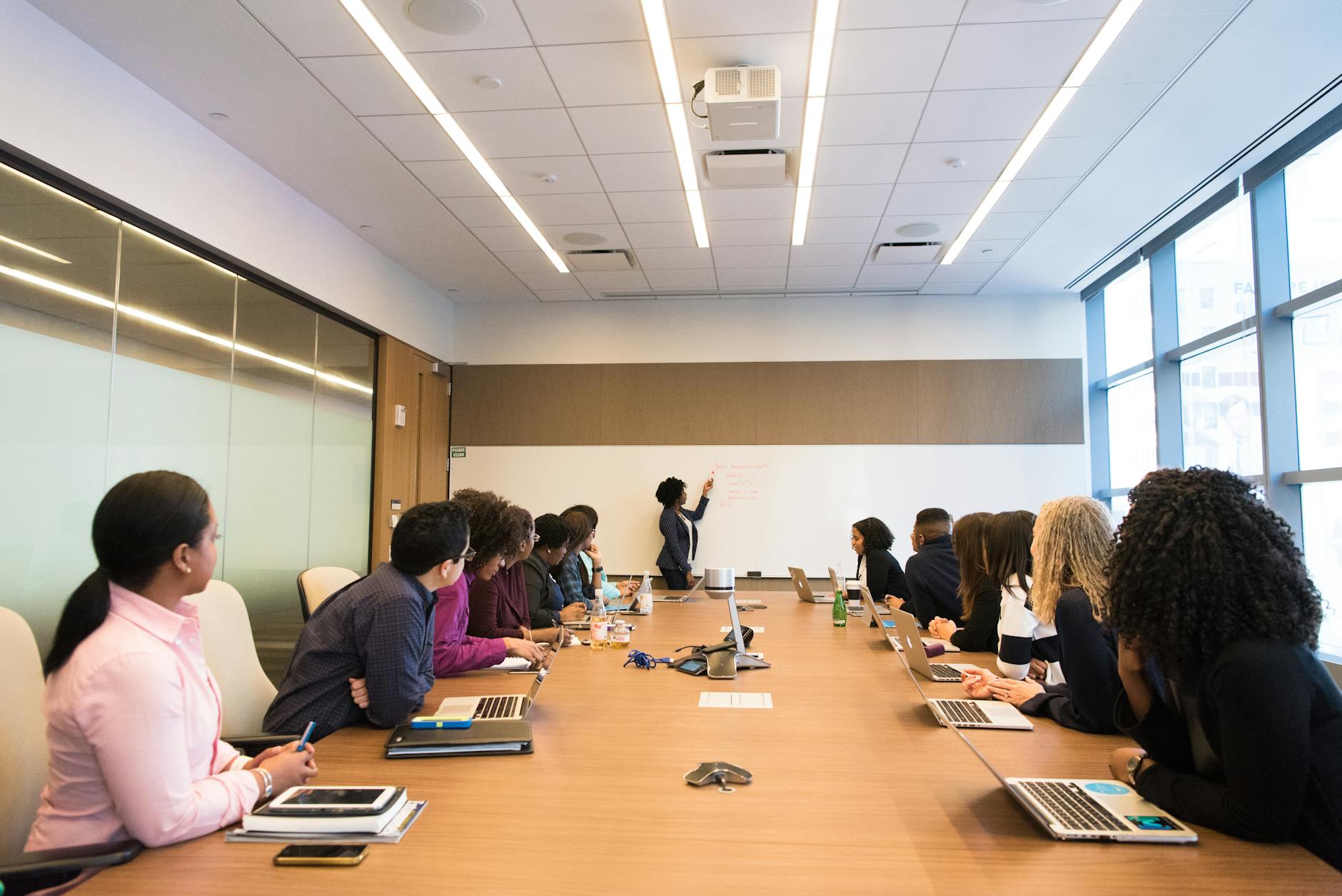 Professional conference room with laptops and documents for investment banking work