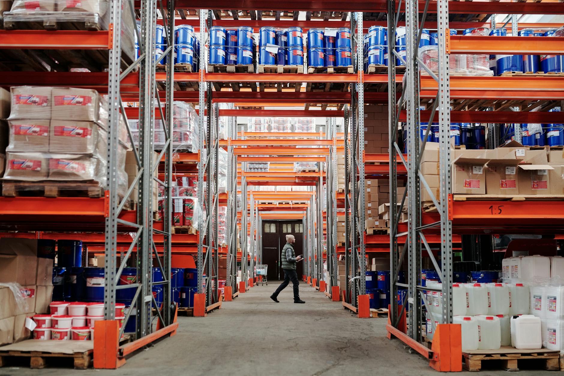 Workers inside a large fulfillment warehouse preparing packages for shipment