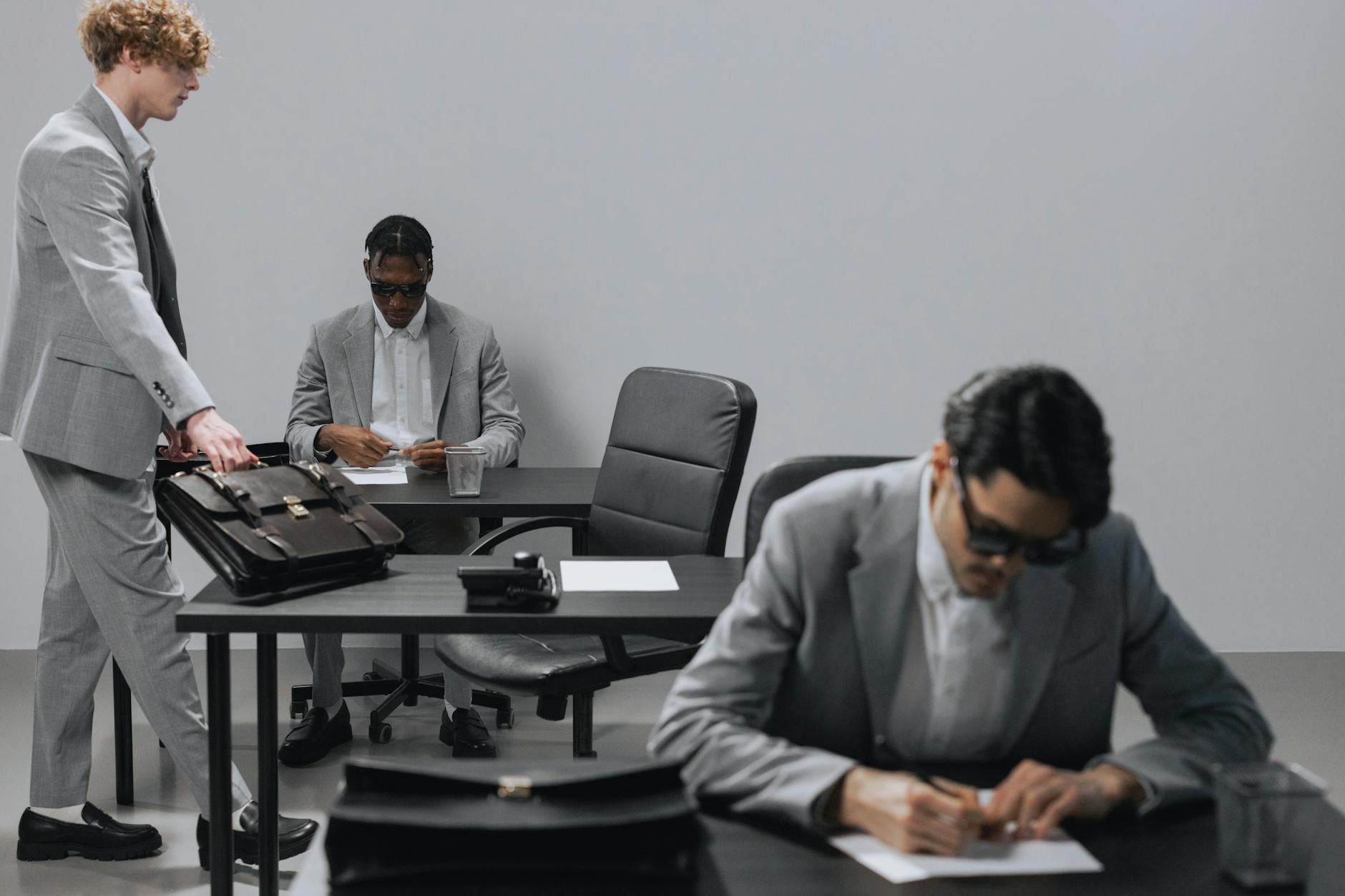 Enterprise professionals in a boardroom reviewing technology solutions on a large screen