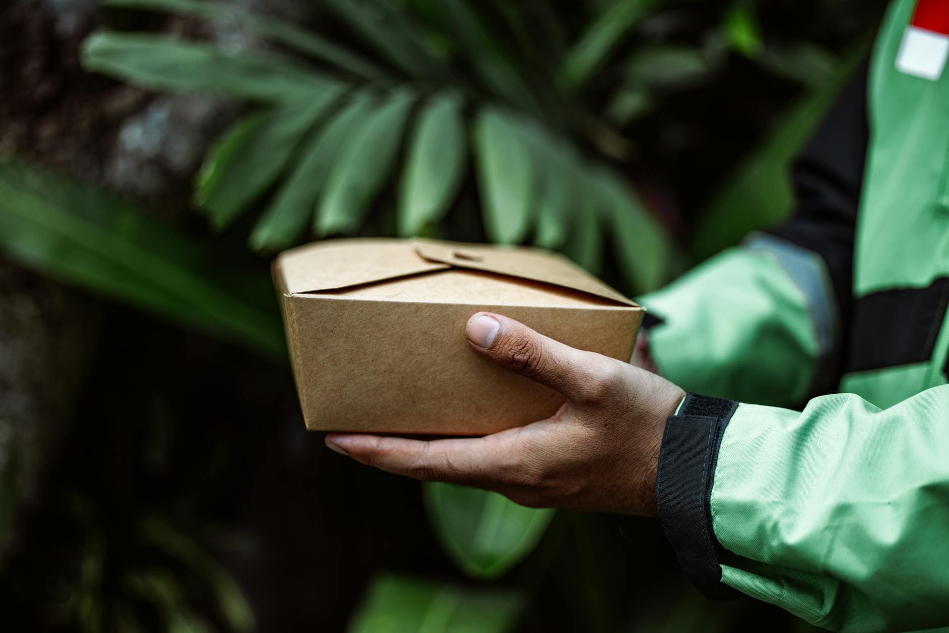 Brown cardboard delivery box sitting on a doorstep