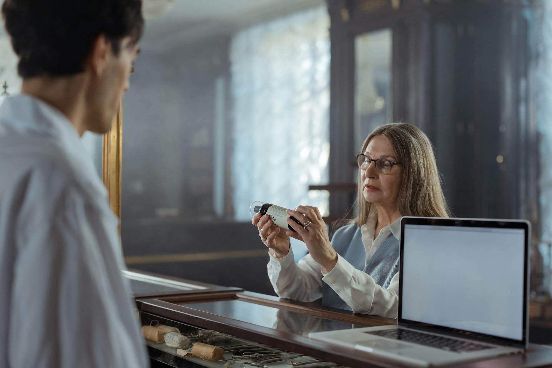 Pharmacist consulting with customer at pharmacy counter