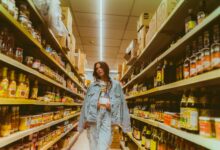 Grocery store aisle lined with store-brand and national-brand products on shelves
