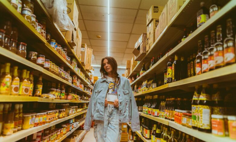Grocery store aisle lined with store-brand and national-brand products on shelves