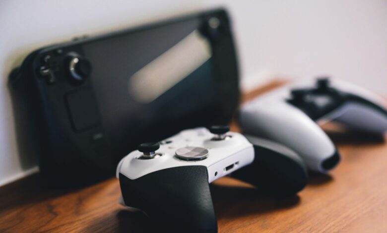 Modern gaming console and controller on a desk with ambient lighting