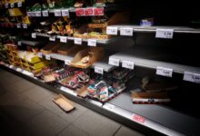 Rows of packaged food products on supermarket shelves representing large consumer brand portfolios